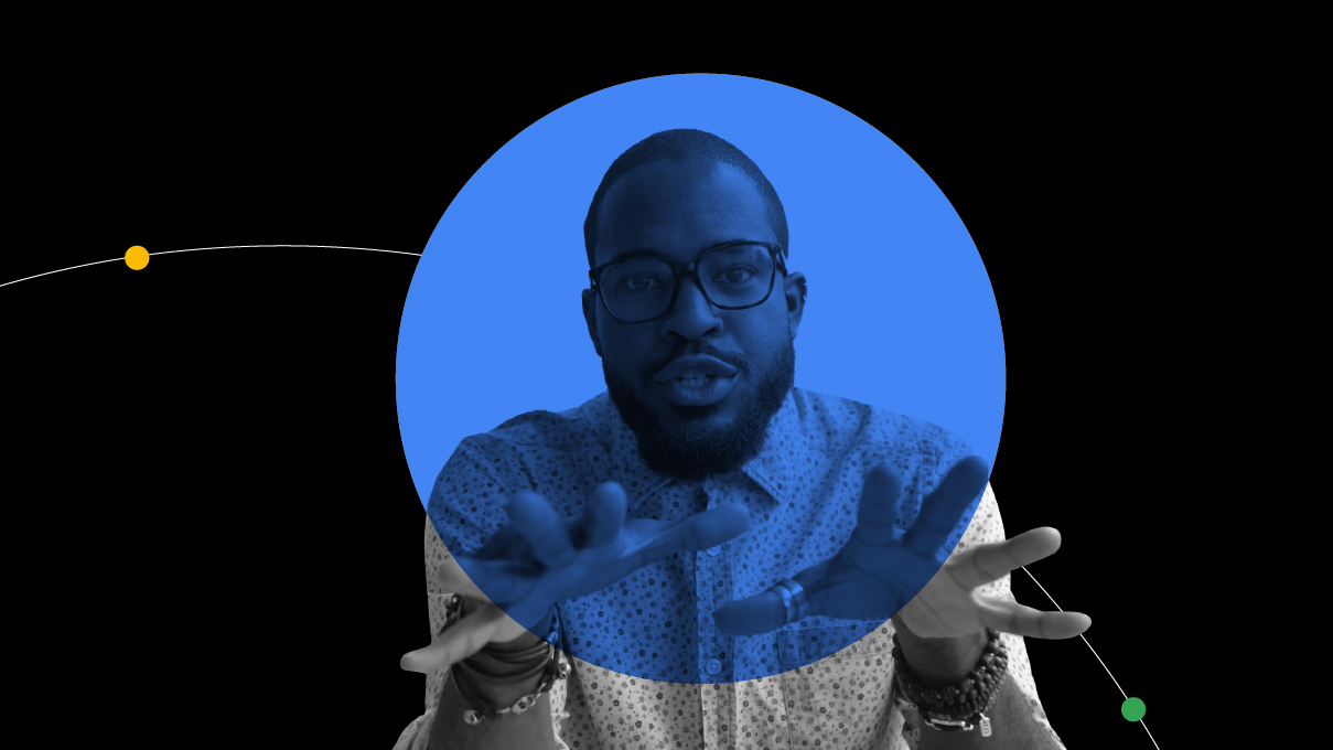 A Black man with short hair and glasses is giving a dynamic video presentation. As he speaks, he gestures toward the other viewers with his hands.