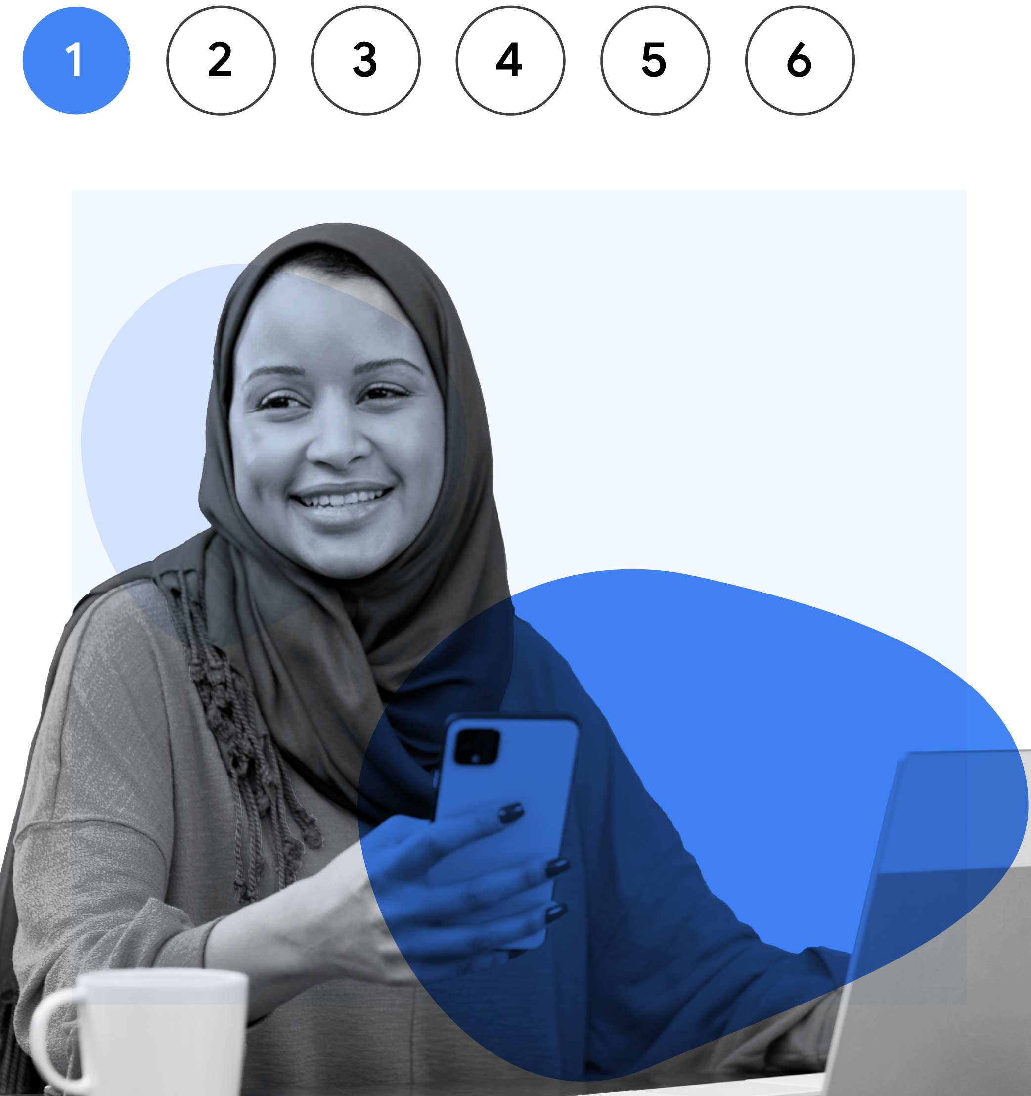 A woman of color wearing a hijab smiles as she holds her smartphone.