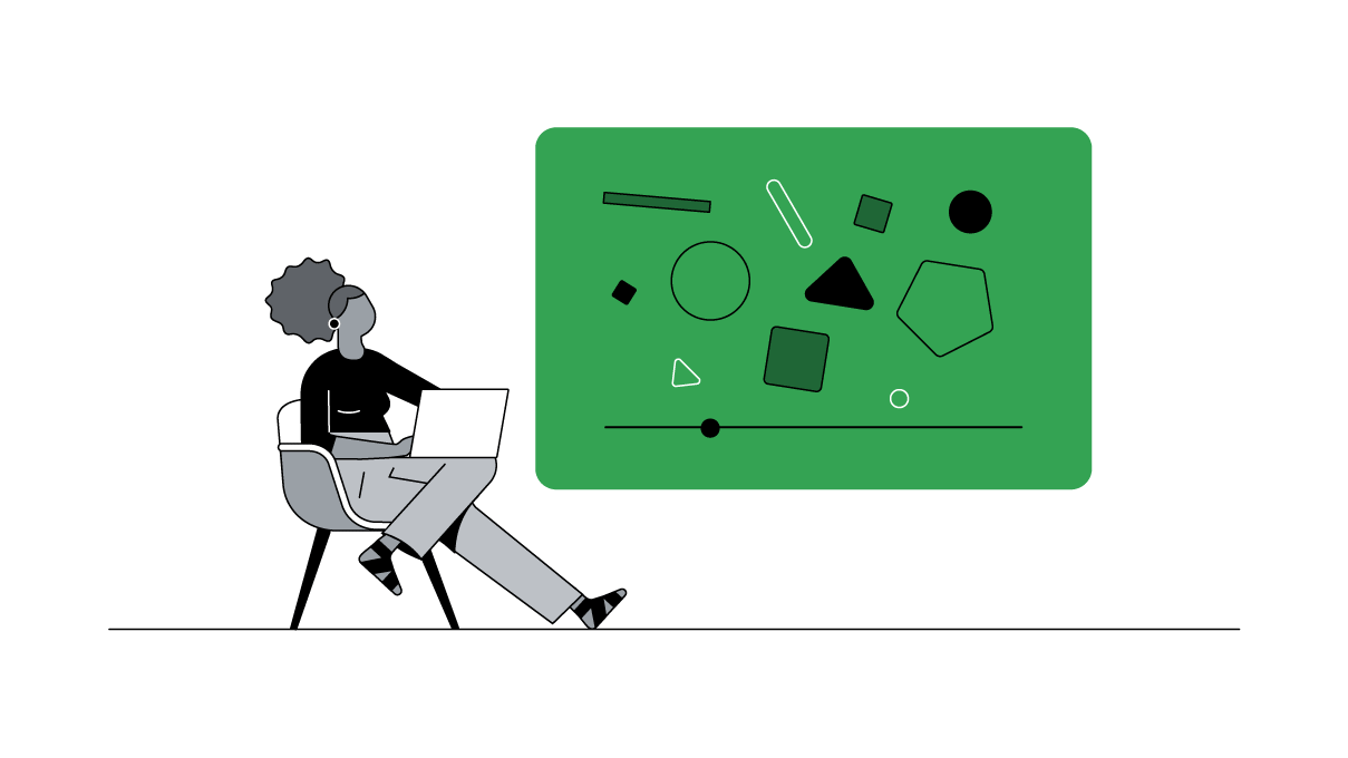 A stylishly dressed Black woman with her hair pulled back in a puff watches a YouTube video on her laptop.