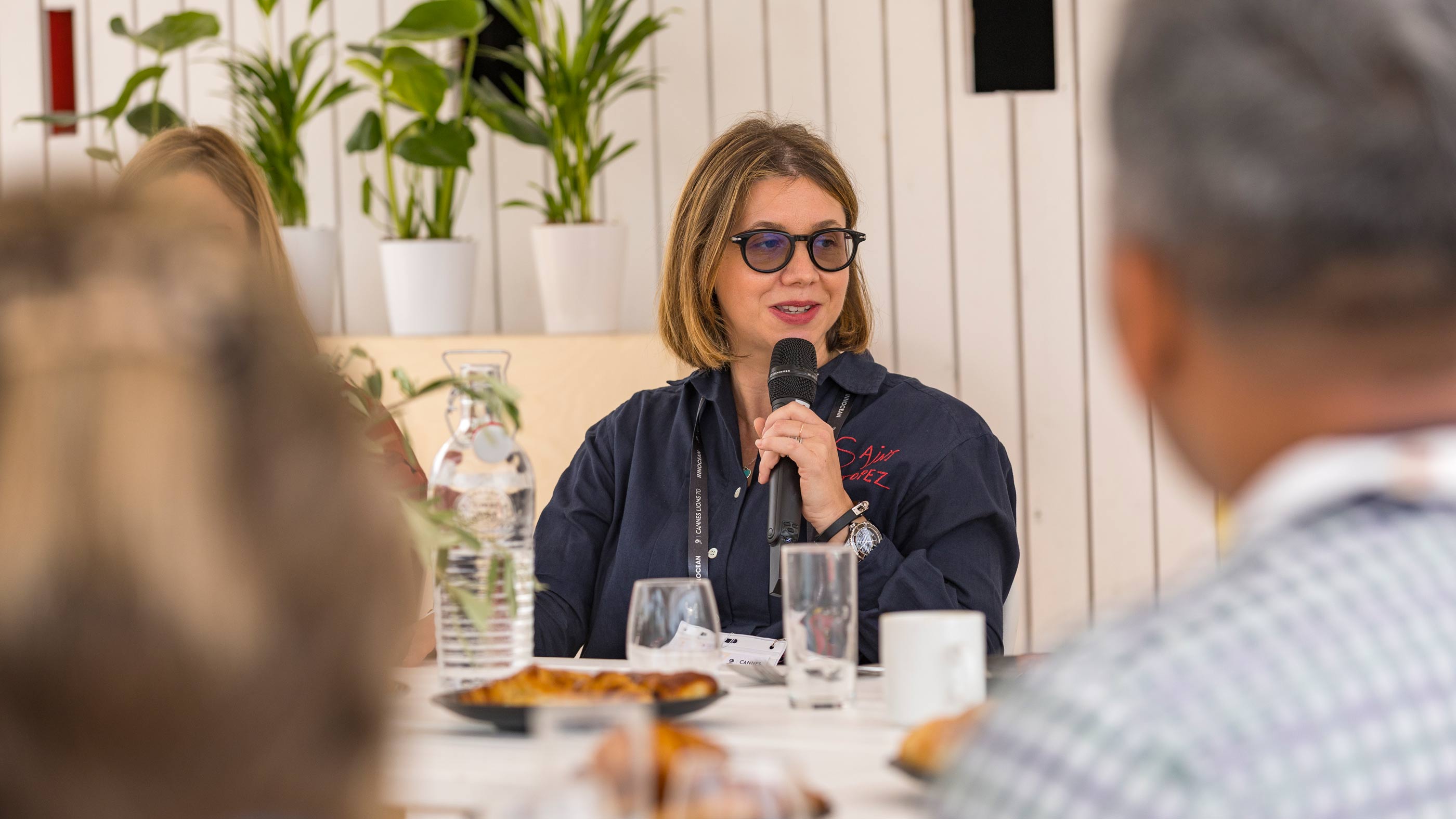 Marie Gulin-Merle, global VP of ads marketing at Google, wears sunglasses and a casual black jacket while speaking at a round-table discussion about the AI revolution during the Cannes Lions International Festival of Creativity.
