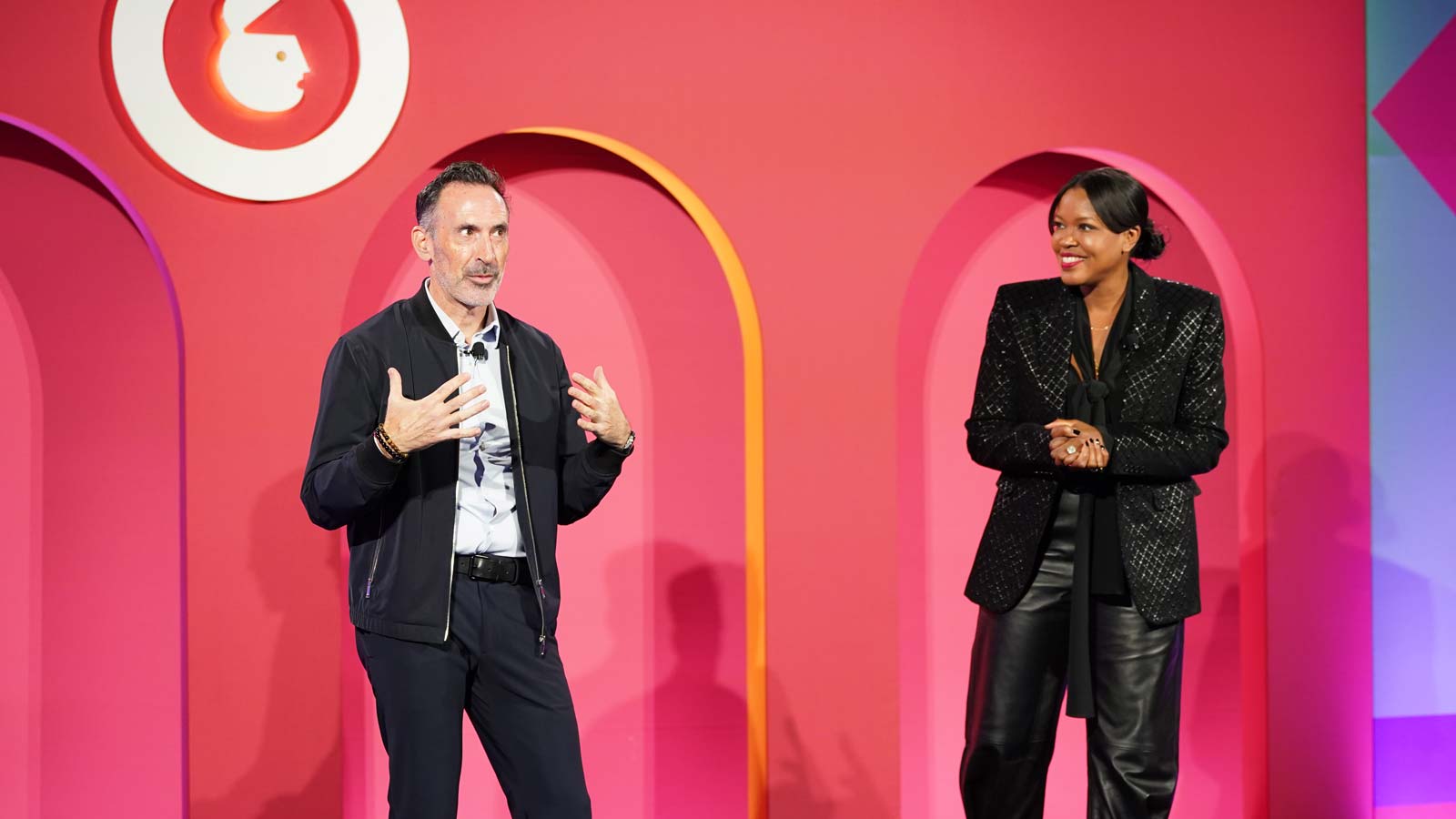 Sean Downey, Google’s President of Americas and Global Partners, stands to the left of Anne Marie Nelson-Bogle, VP of YouTube Ads Marketing, as they address a crowd of conference goers about what AI can do for businesses.