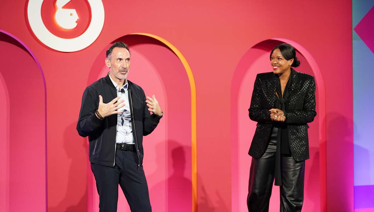 Sean Downey, Google’s President of Americas and Global Partners, stands to the left of Anne Marie Nelson-Bogle, VP of YouTube Ads Marketing, as they address a crowd of conference goers about what AI can do for businesses.