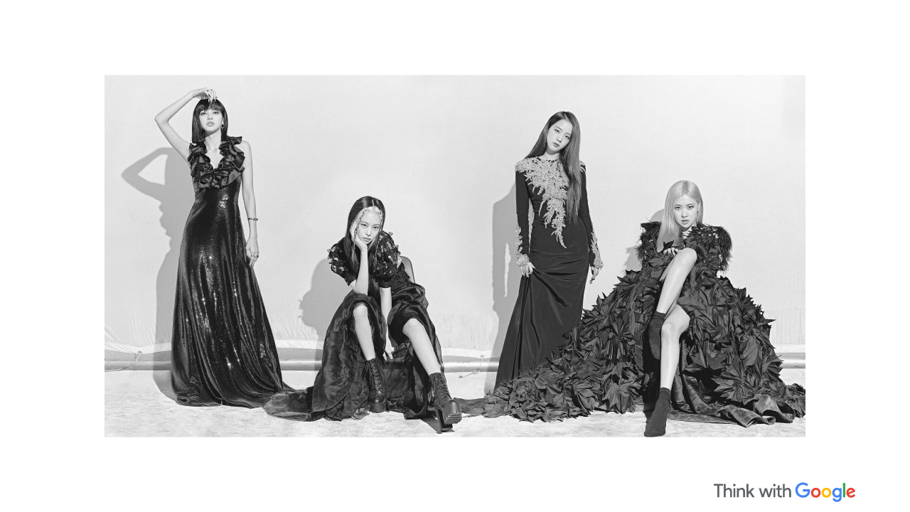 The four members of Blackpink, Jisoo, Jennie, Rosé, and Lisa, pose in black evening gowns and high-heeled boots.