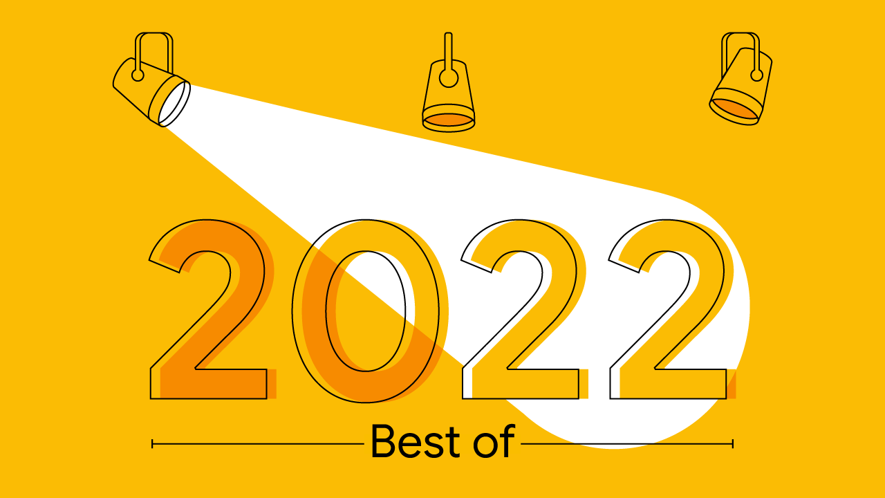 Un’illustrazione a sfondo giallo mostra tre riflettori che proiettano una luce bianca a occhio di bue. Questa illumina un grande numero, il 2022