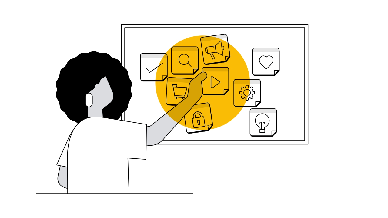 Una persona con cabello rizado y negro señala una pizarra con un círculo amarillo. En la pizarra aparecen notas adhesivas con corazones, candados, engranajes, lámparas eléctricas, carritos de compra y logos de YouTube.
