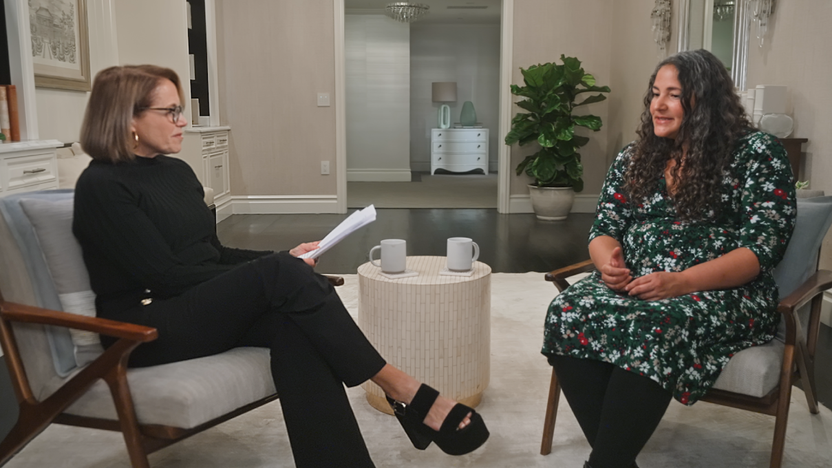 Future Ready: Happiness with Katie Couric and Dr. Laurie Santos. Couric has short, light brown hair, light skin, and wears a black turtleneck and black pants. Santos has long, dark wavy hair, medium skin, and wears a floral print dress.