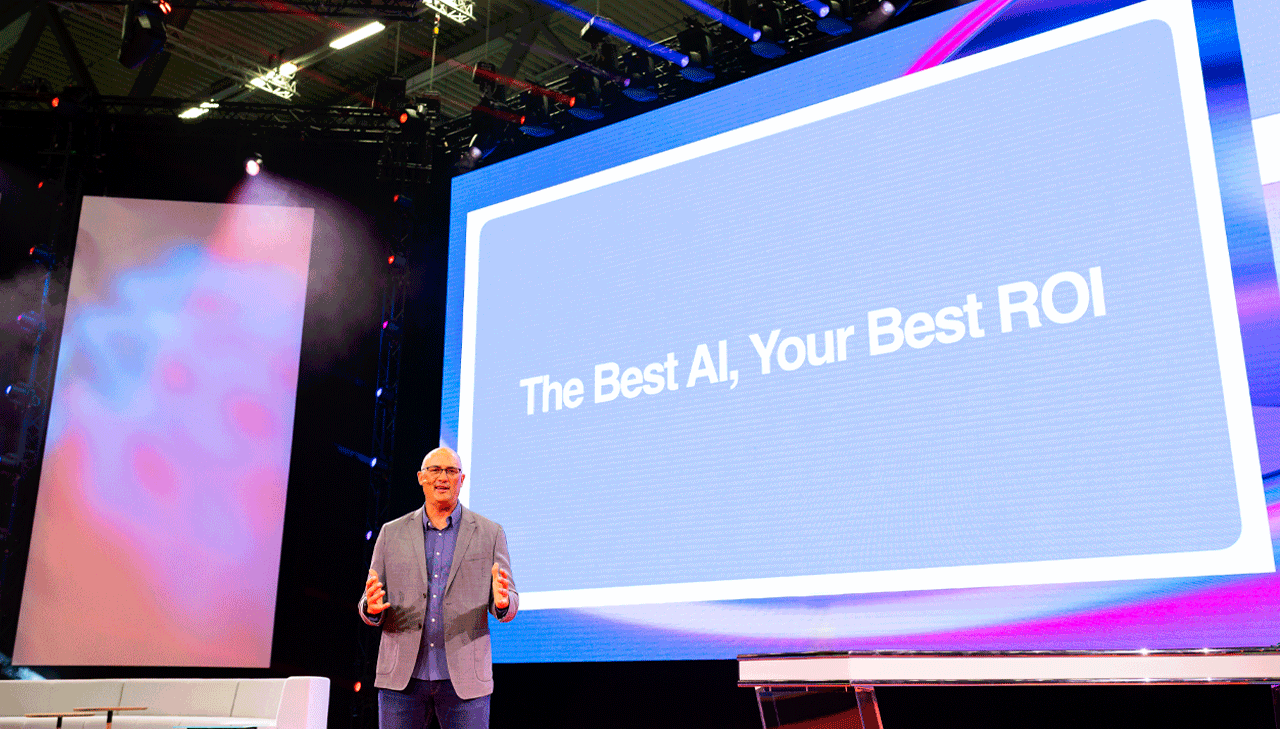 Brendon Kraham, VP of search and commerce, global ads solutions at Google, speaks from the stage at DMEXCO in Cologne, Germany, in front of a pale blue screen with white lettering that reads: The Best AI, Your Best ROI.