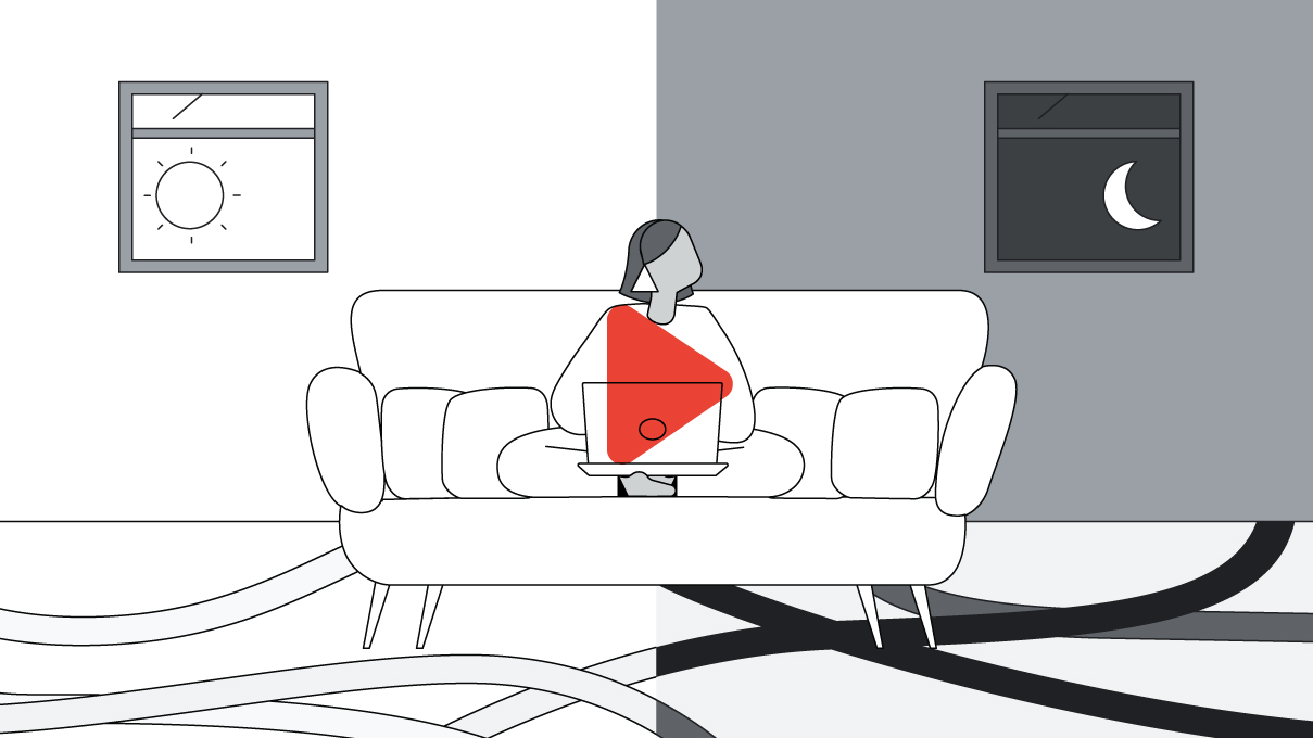 In black and white, a woman sits on a sofa with her laptop, between 2 windows. The left half of the room is light-coloured, with the sun outside, and the right half is dark-coloured, with the moon outside. A red life-size play button overlays the centre.