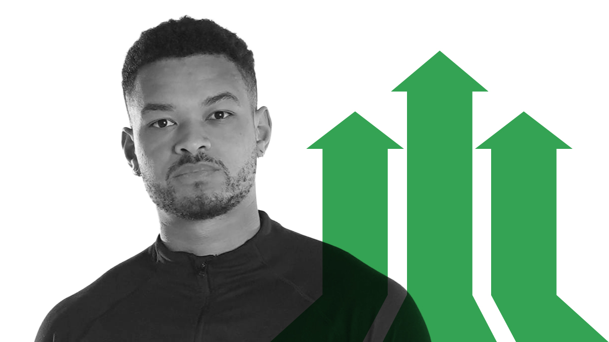 Steven Bartlett, pictured in black and white from the chest up. He has dark skin, short hair, a trimmed beard and is wearing a track jacket. To the right, a green overlay of three arrows pointing upwards. The middle arrow is taller than the other two.