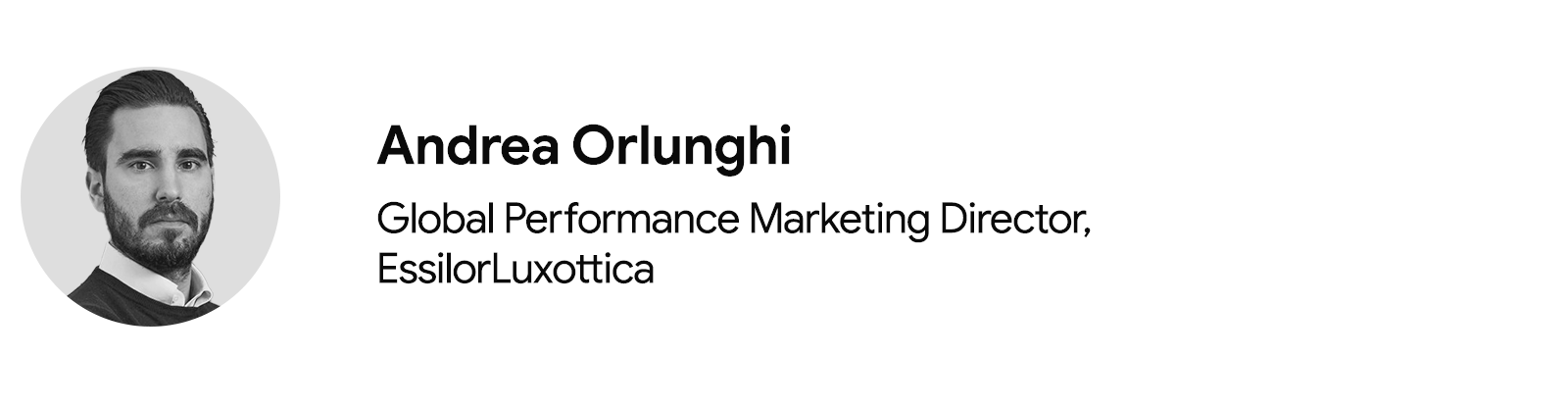 Andrea Orlunghi, Global Performance Marketing Director at EssilorLuxottica is pictured from the shoulders up. Orlunghi has light skin, short dark hair with a neat beard and mustache, and wears a white collared shirt under a dark crew-neck sweater.