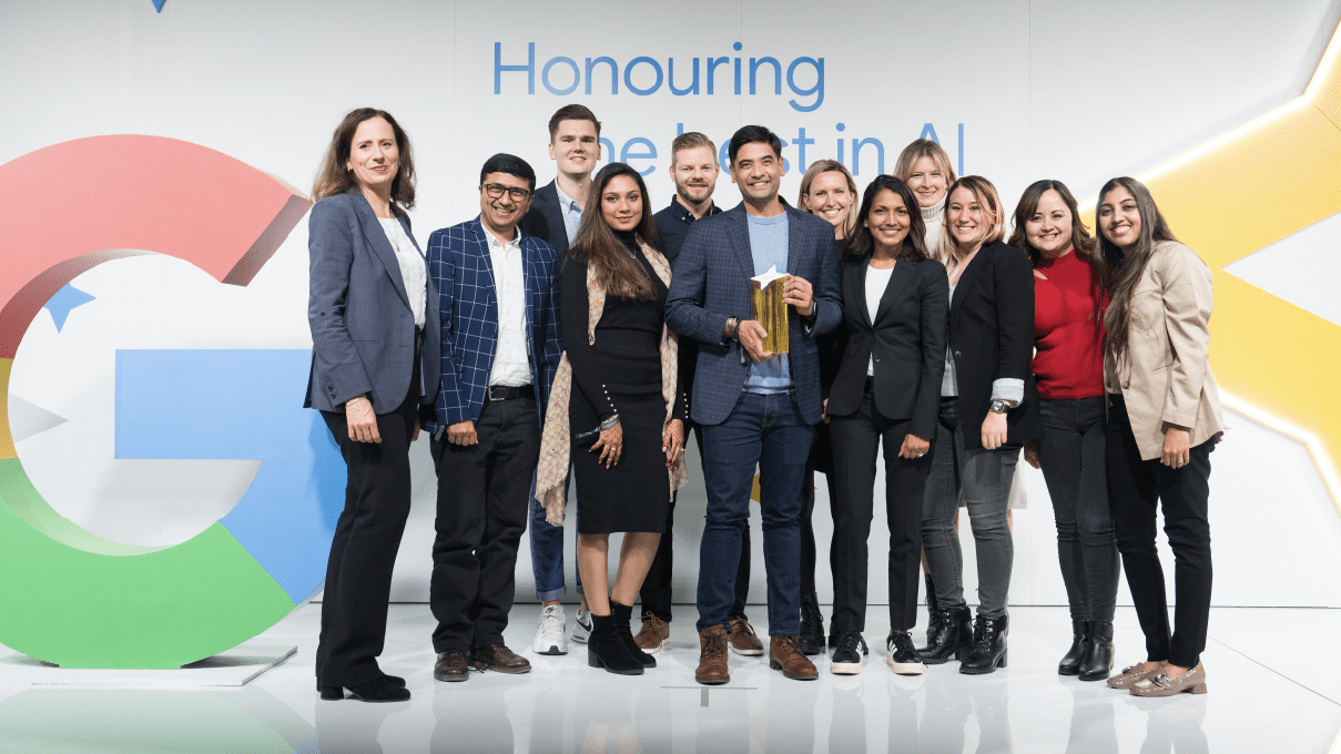 Members of Intuit QuickBooks Canada smiling. The man in the center is holding the Google Search Honours Award trophy.