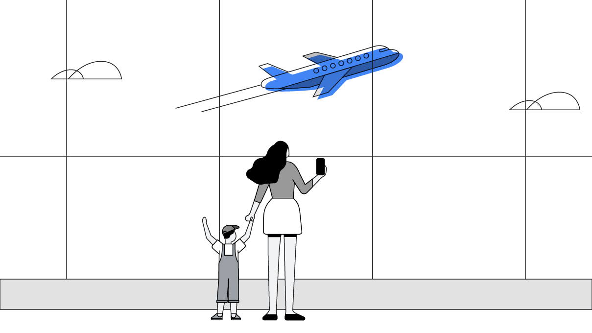 Une femme qui tient la main de son enfant et qui filme un avion