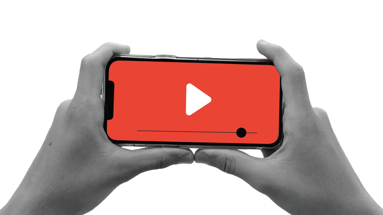 A user holding a mobile phone with both hands and watching a YouTube video, representing how brands can create online video creatives that drive sales using digital video marketing tips picked up from YouTube Works 2021 success stories.