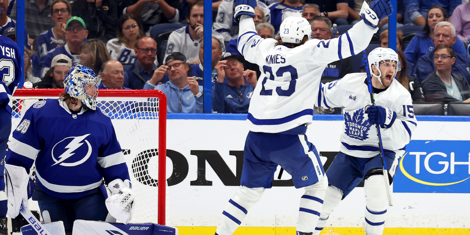 Two Toronto Maple Leafs players celebrate a goal during the 2023 NHL playoffs against the Tampa Bay Lightning.
