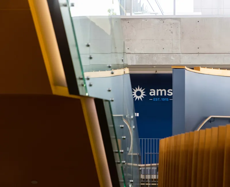 Inside the Nest, the AMS logo appears, hidden between stairs and a wall.
