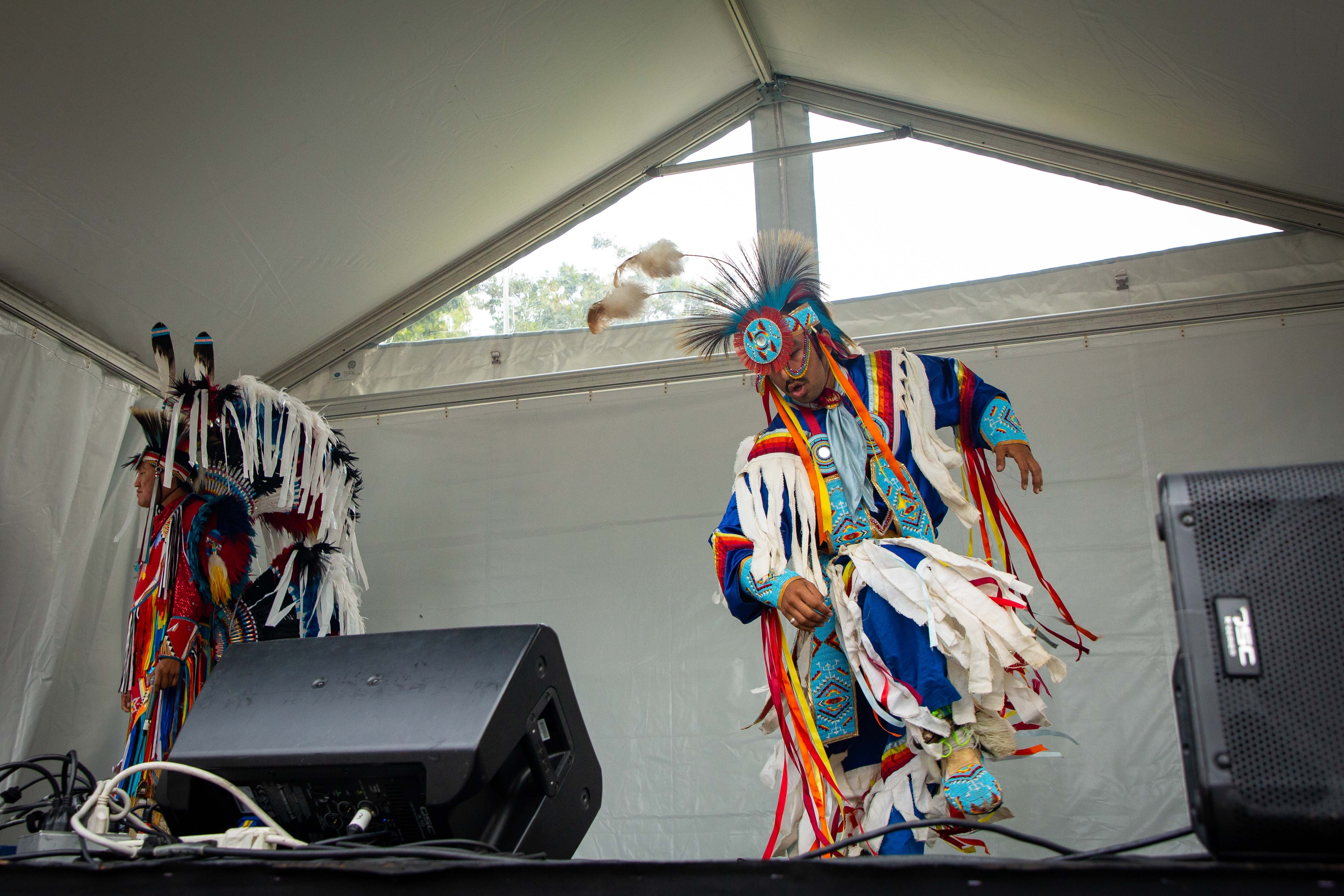 Members of Indigenous Enterprise, a troupe of dancers from Canada and the US, perform on stage.