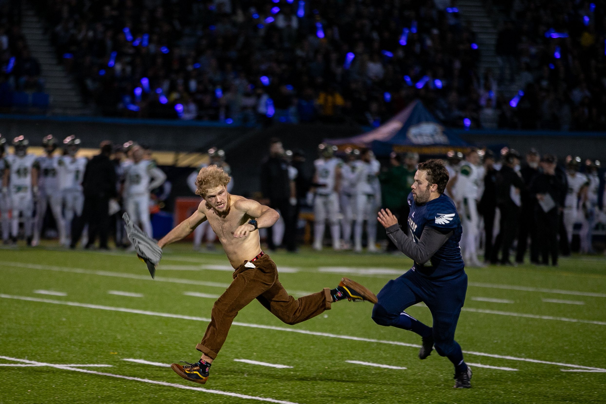 Streaker narrowly escapes pursuing UBC player.