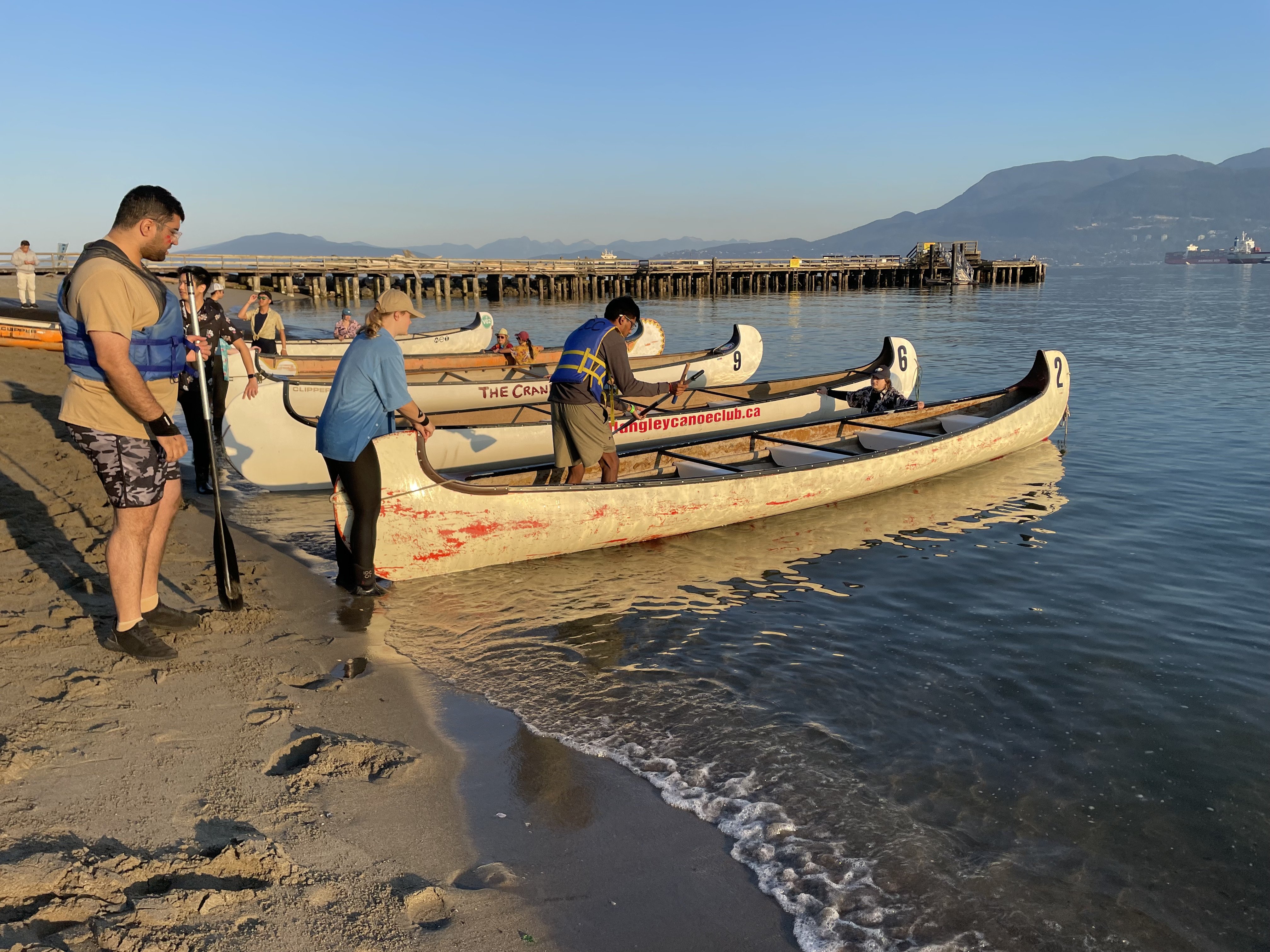 The tow crew help participants get into the canoes before the start of the race.