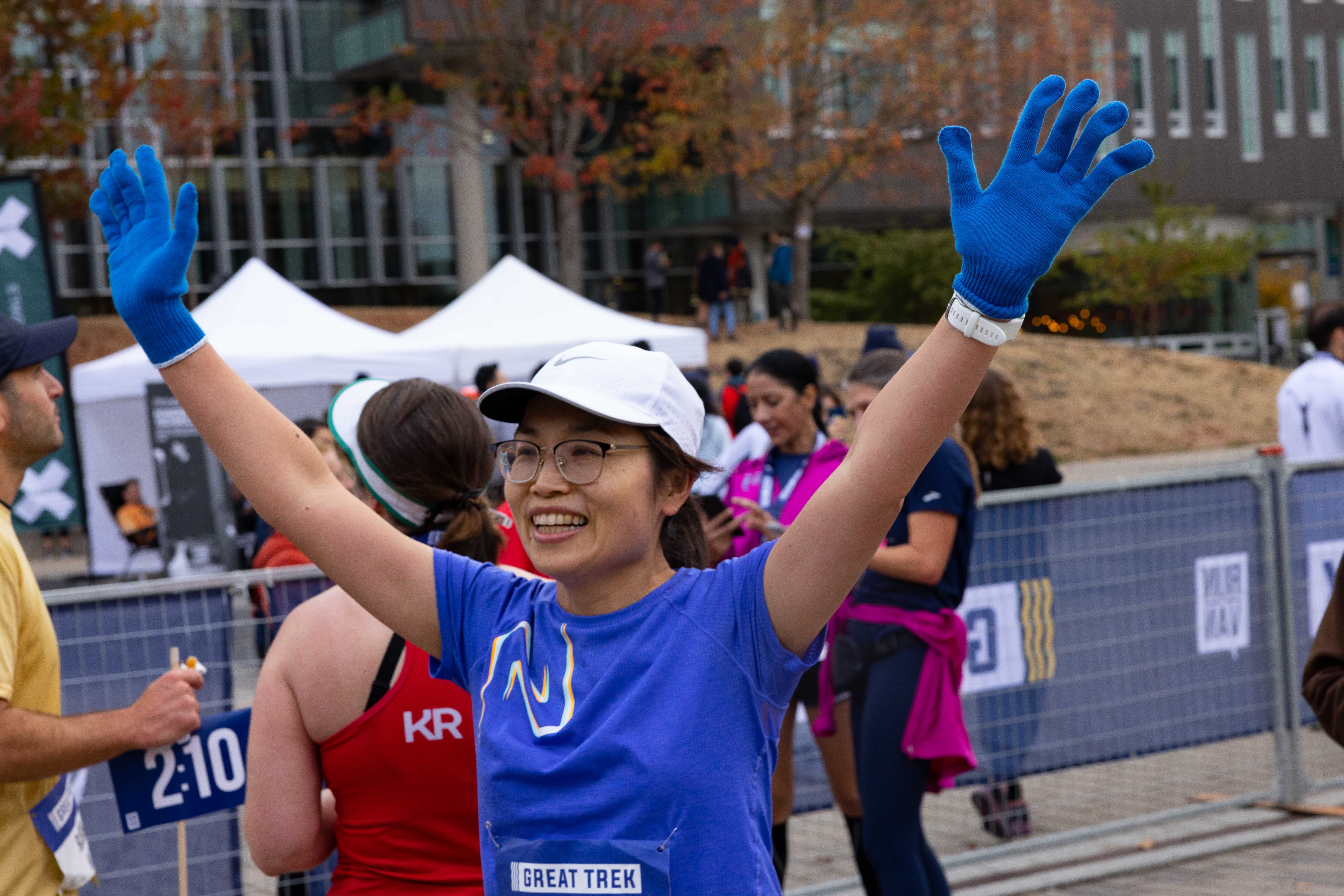 A runner celebrates at the finish line.