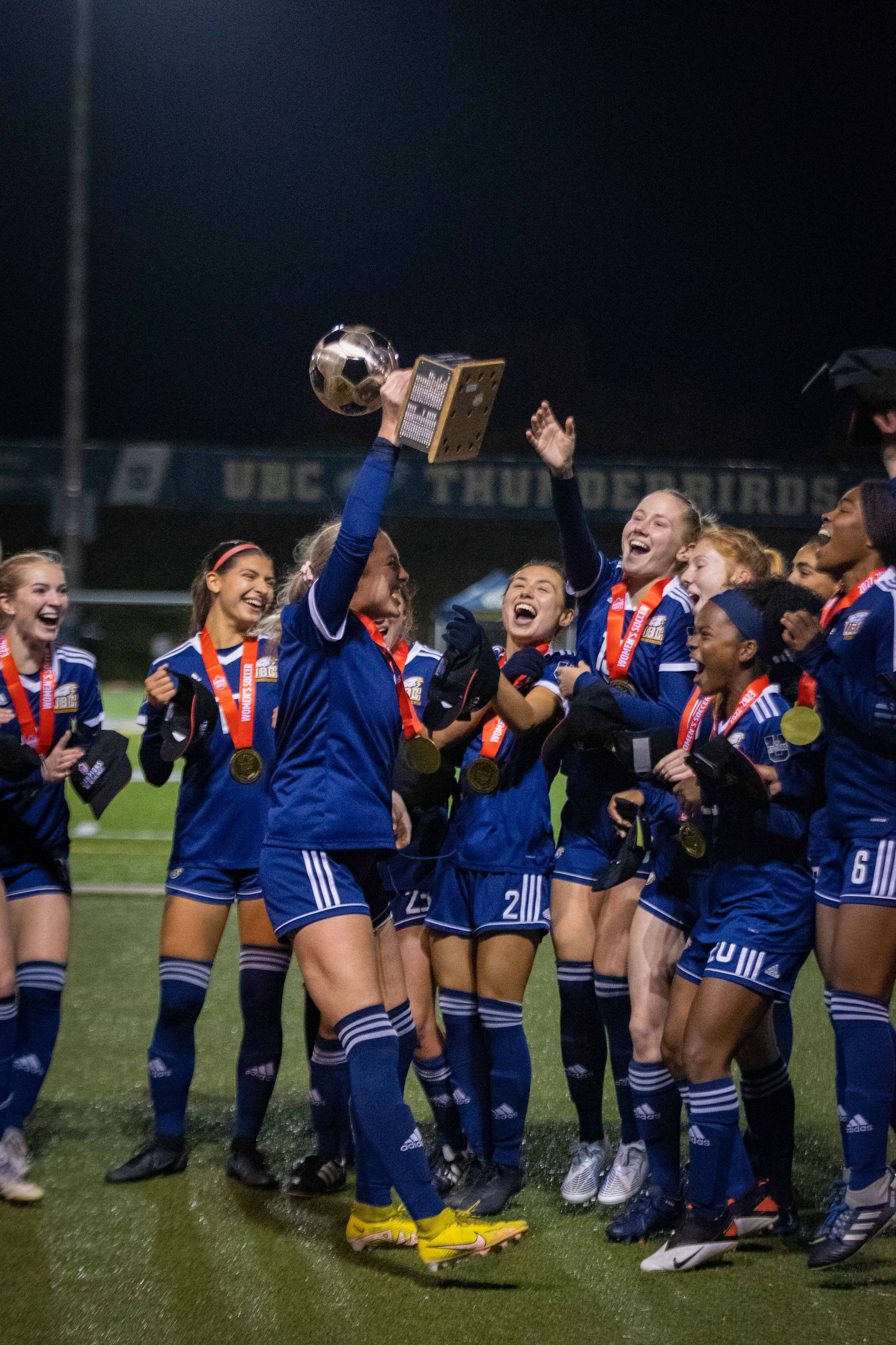 The Thunderbirds lift their 16th Canada West women's soccer championship trophy.