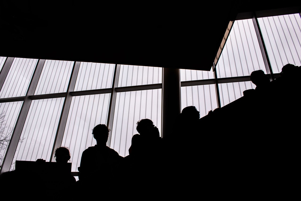 Silhouettes of students climbing the stairs of the Robert H. Lee Alumni Centre to the board room on the top floor.
