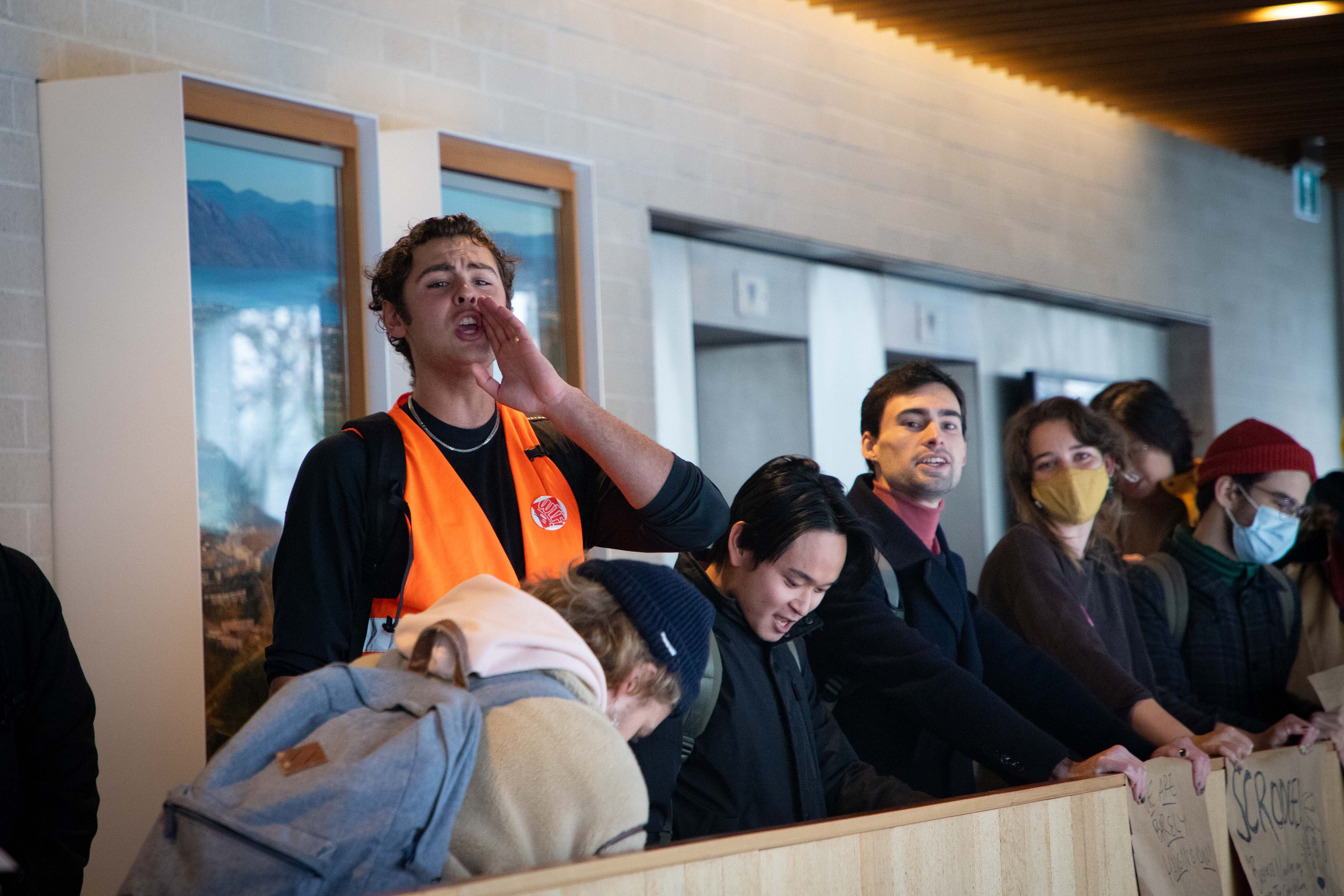 Protestors shout from the top floor of the Robert H. Lee Alumni Centre to express opposition to the proposed tuition increase.