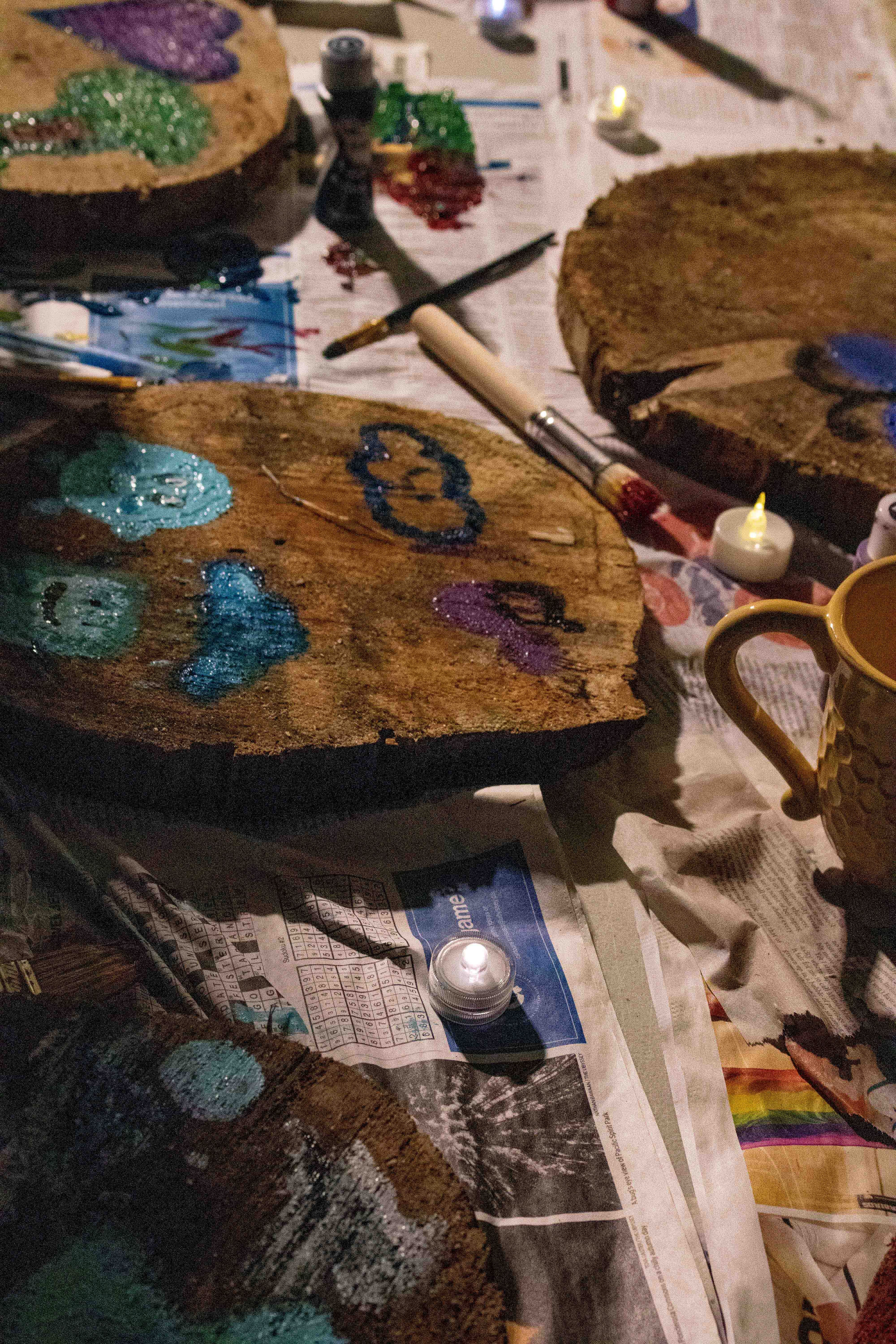 Community-painted tree cookies sit out to dry.