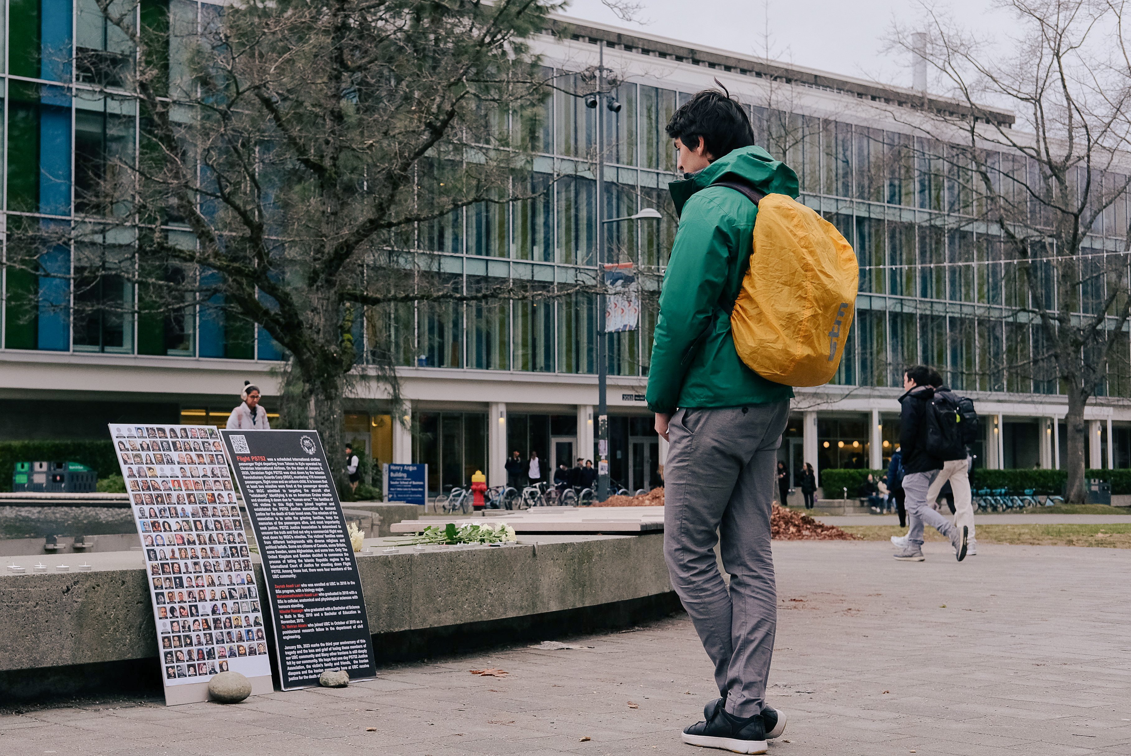 Hosseini stands in front of the Flight PS752 memorial in front of the Martha Piper Plaza.