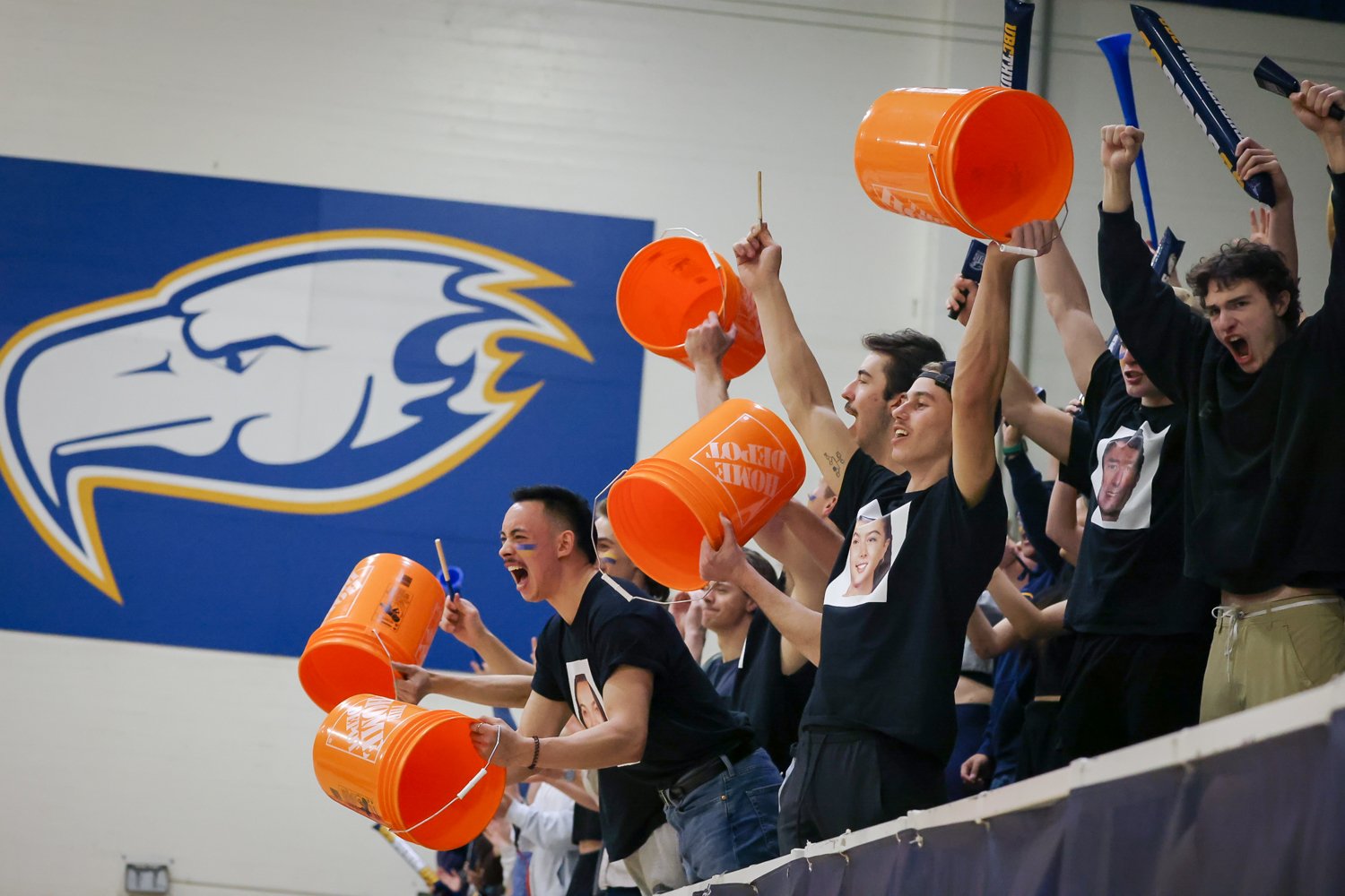 T-Birds fans led by men's volleyball players Coltyn Liu and Matt Neaves show their support for the women's team.