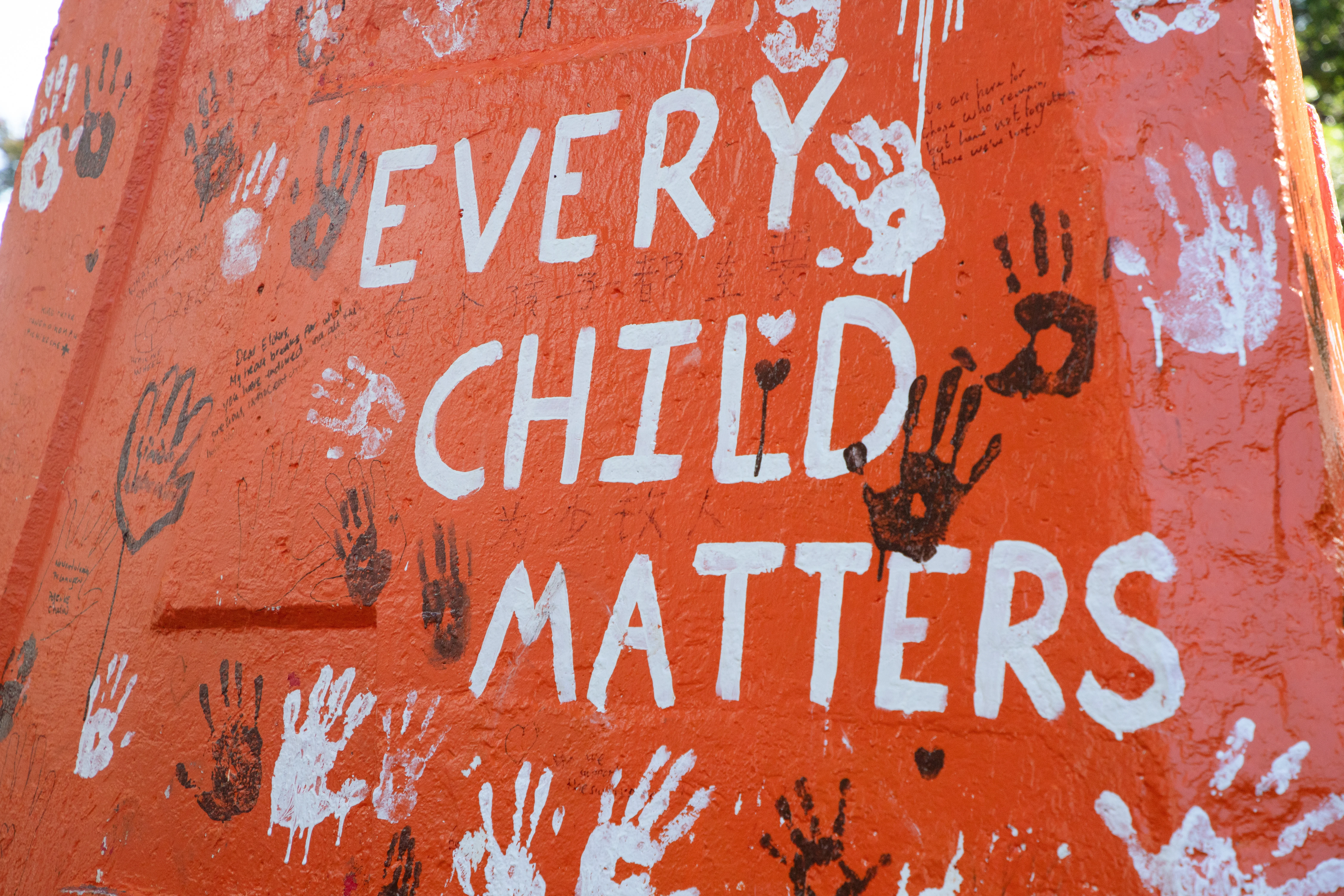 As the crowd dispersed after the march, many lingered to add more written messages of support, solidarity and handprints to the Cairn.