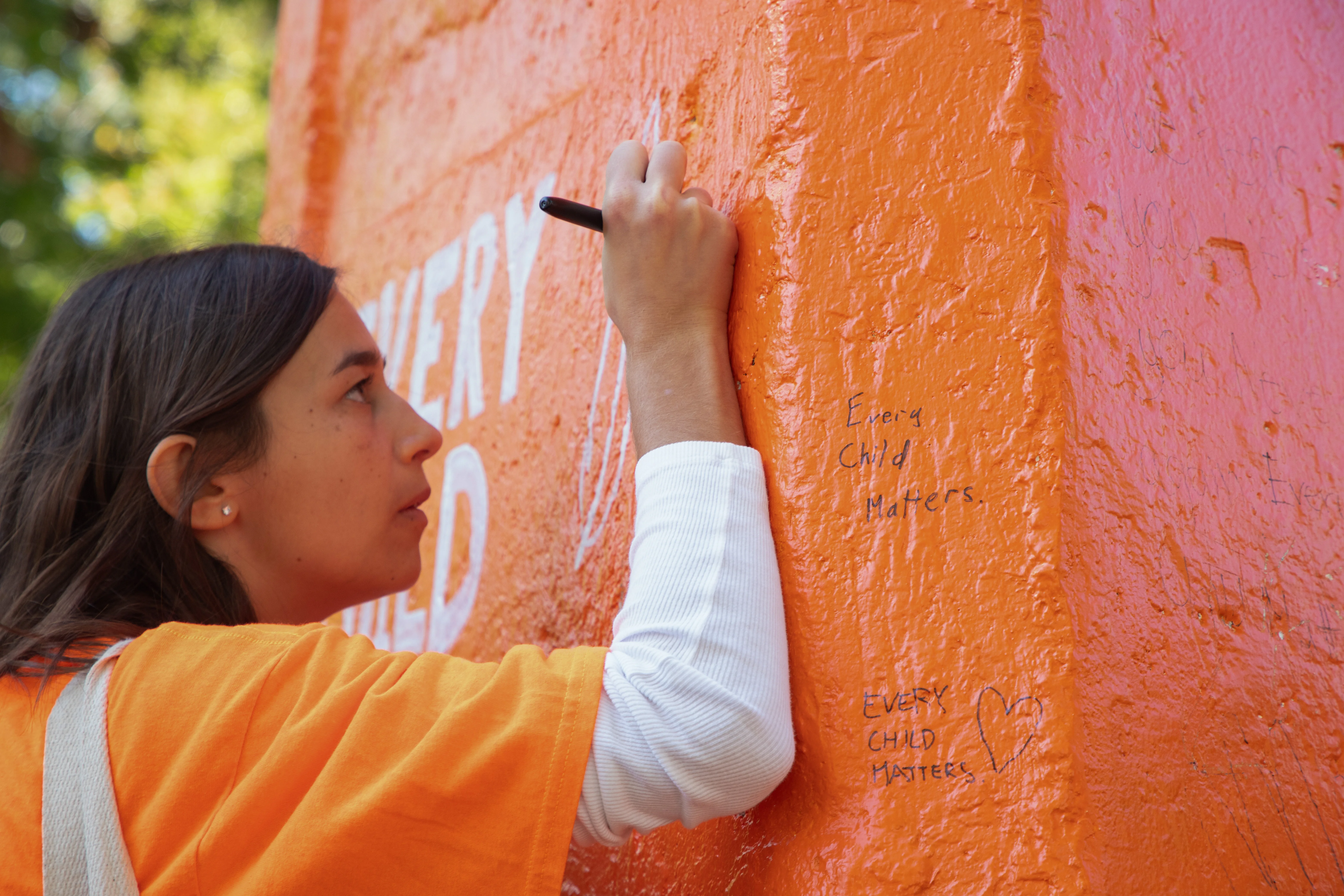 As marchers crossed Main Mall, some left messages of solidarity on the Engineering Carin which had been painted orange for the occasion.