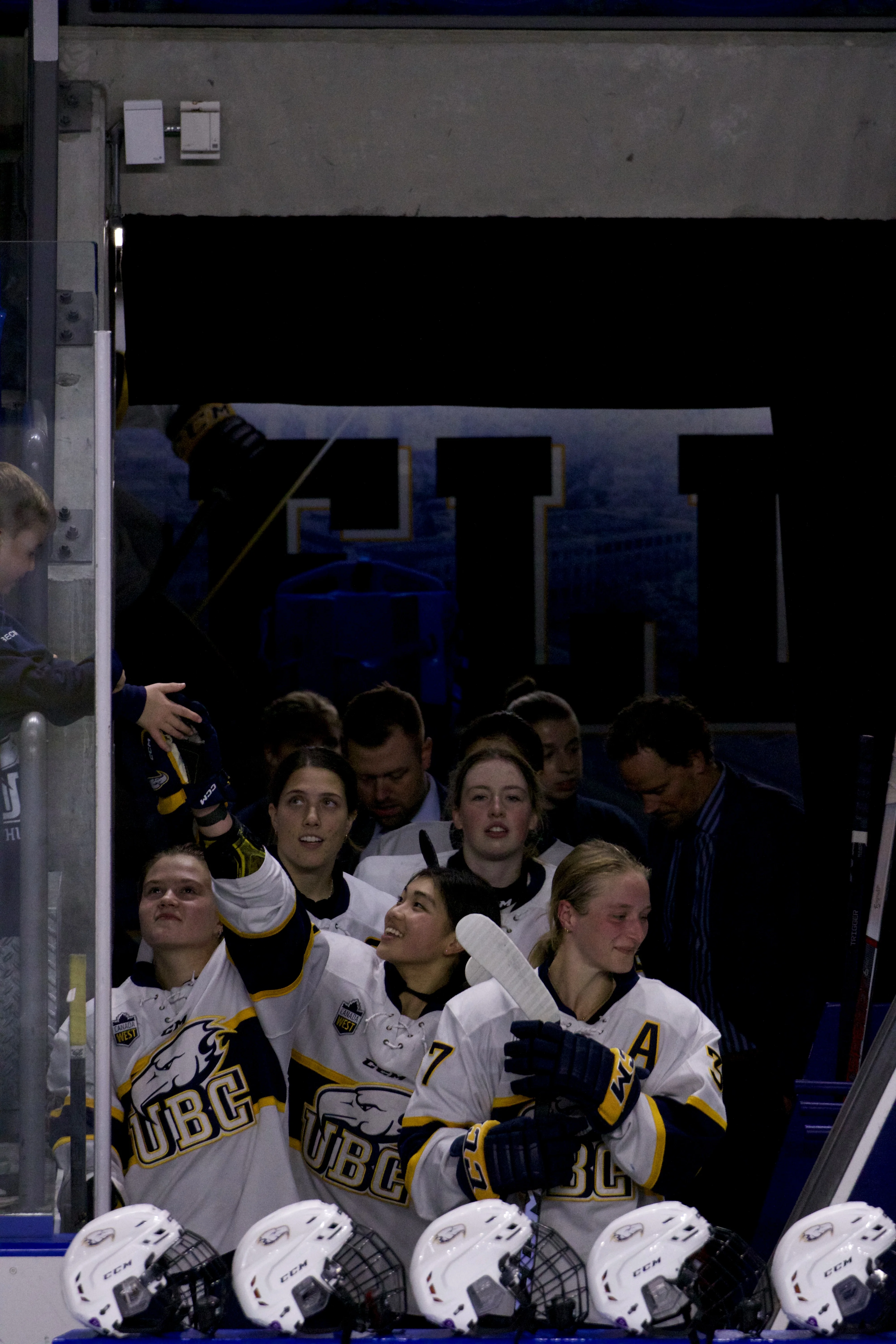 Annalise Wong high-fives a fan in the stands.