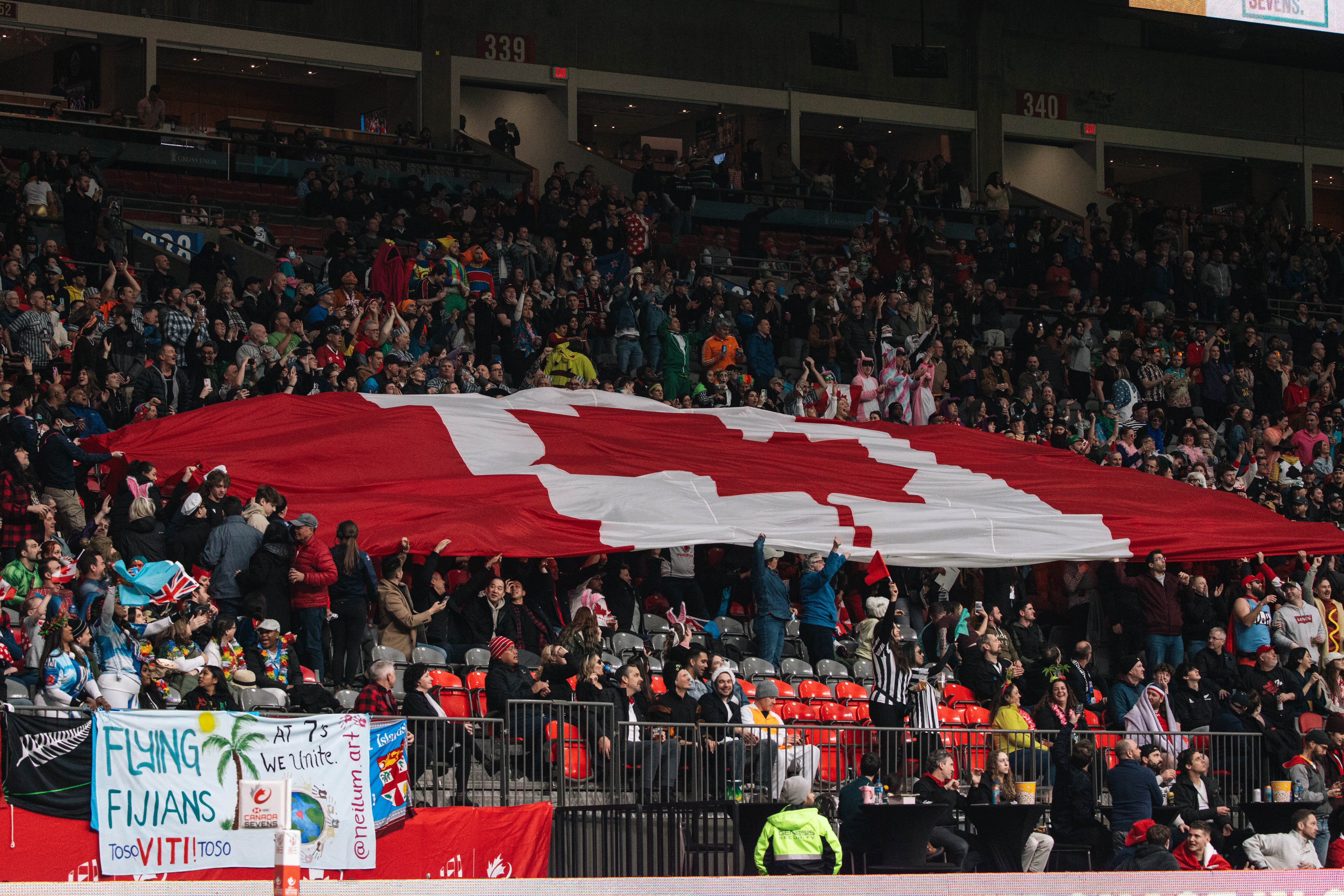 The crowd passes a giant Canada flag across the bowl ahead of Canada versus Chile.