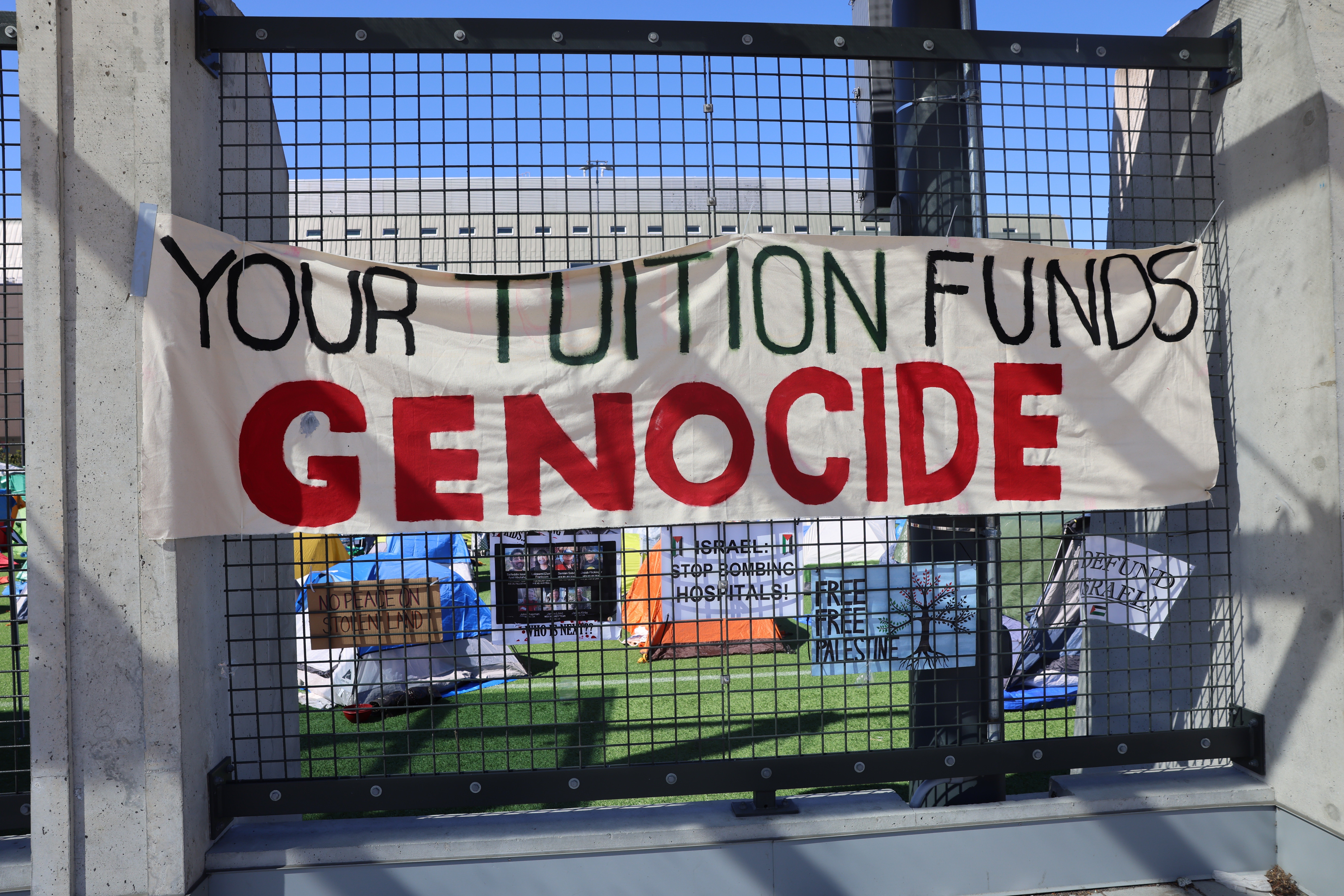 A sign in the encampment which reads 'Your tuition funds genocide.'