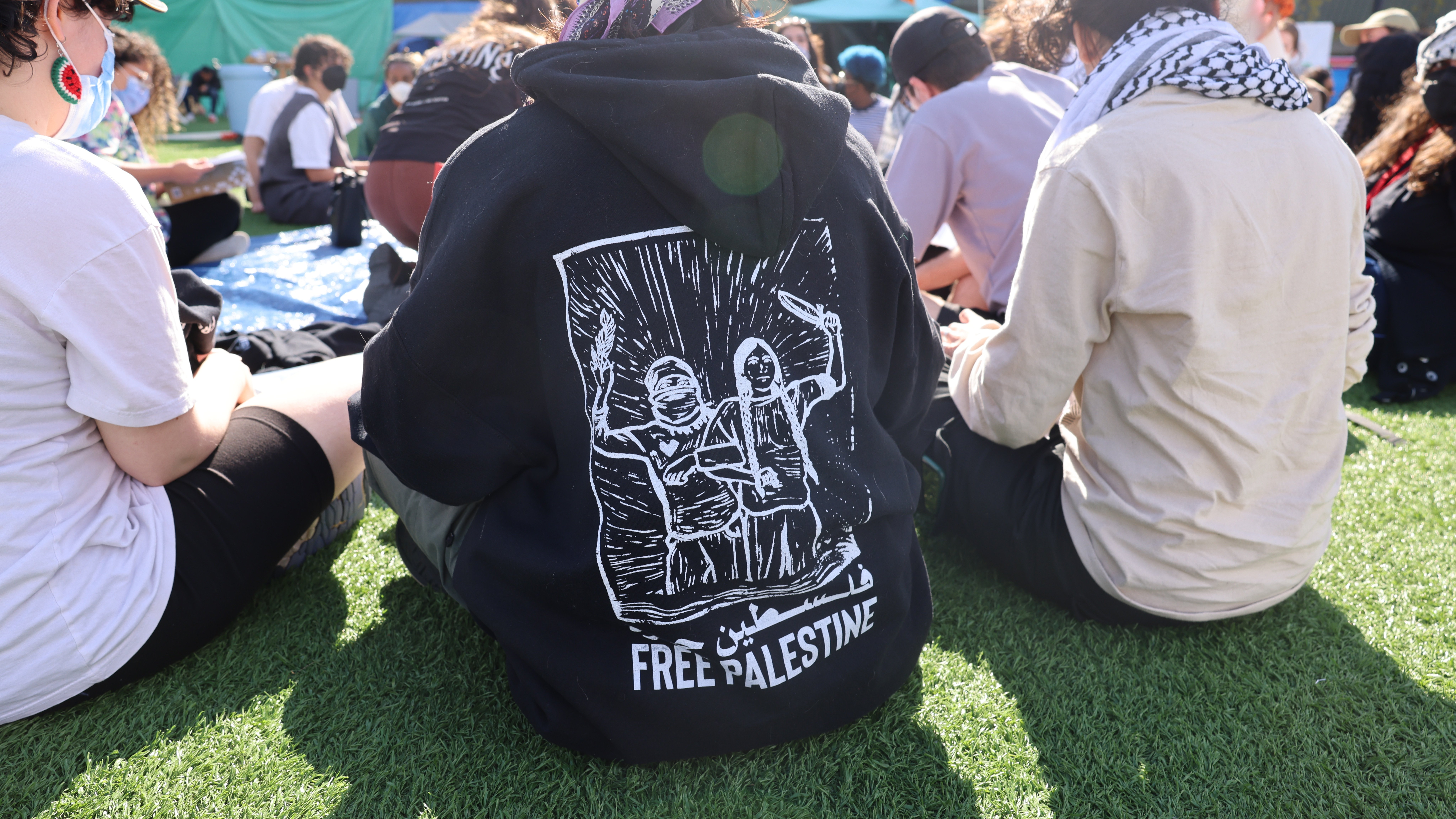 The back of an attendee's hoodie that reads 'Free Palestine.'