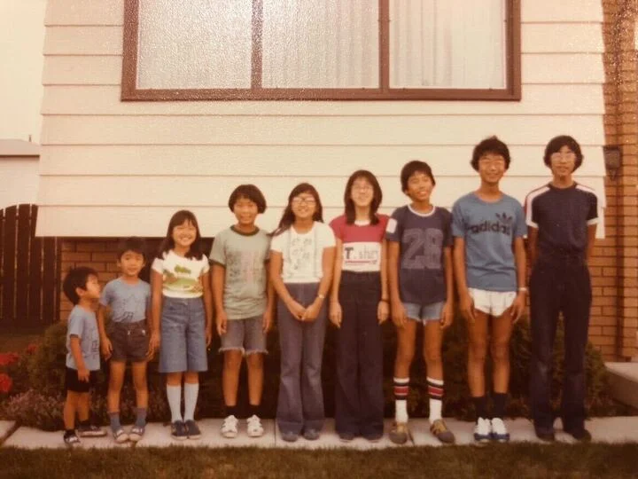 Takasaki's family outside, standing from shortest to tallest.