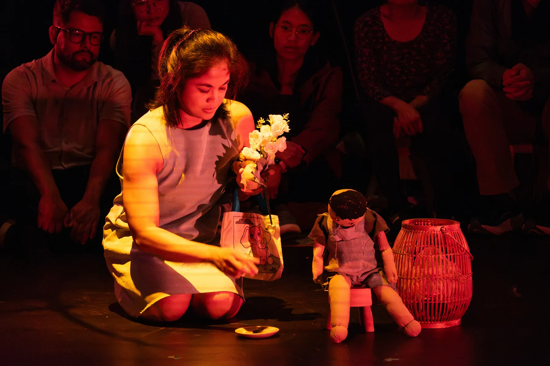 A woman and a doll onstage