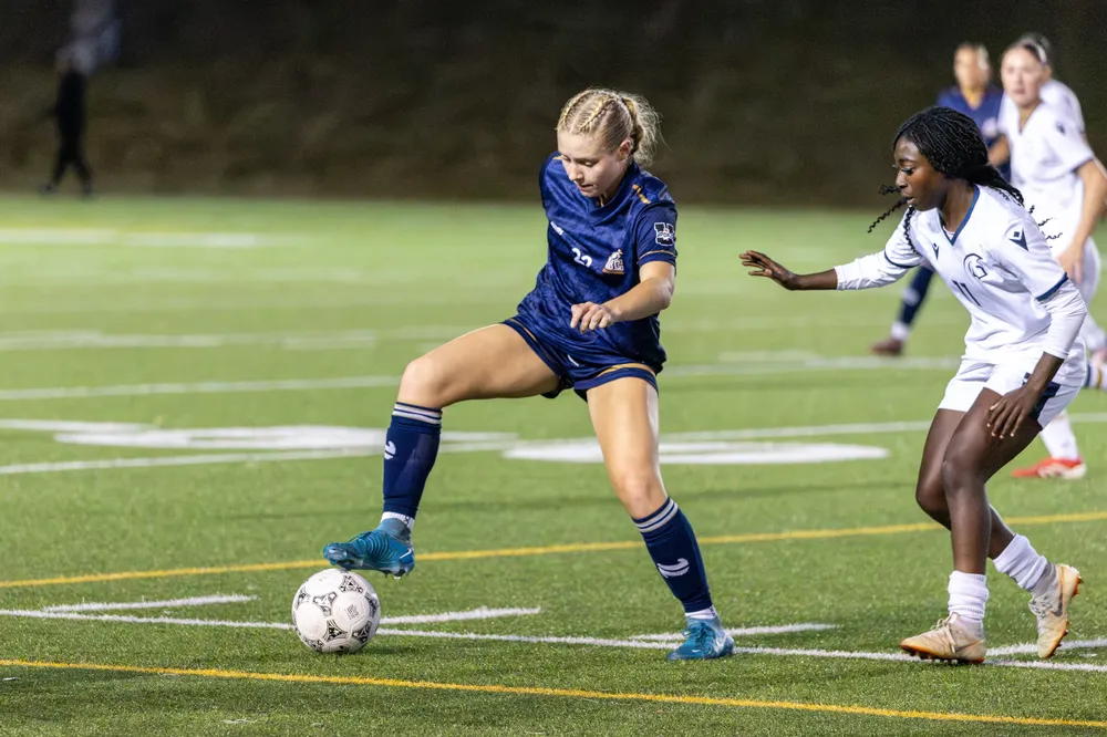 Chloe Van Schalkwyk controls the ball in front of an oncoming Spartans defender.