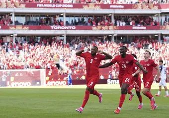 Canada's Cyle Larin (9) celebrates after scoring his side's first goal of the game with Promise David (24) during the second half of the World Cup Group B soccer match between Canada and Bosnia, Friday, June 12, 2026, in Toronto.