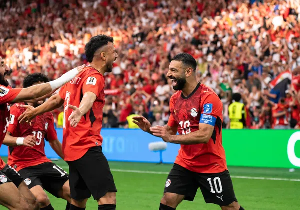 Salah celebrates with his teammate, Trézéguet, after he scored the third goal of the match for Egypt.