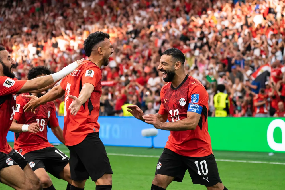 Salah celebrates with his teammate, Trézéguet, after he scored the third goal of the match for Egypt.