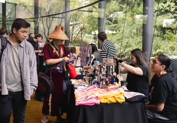 Festival goers examine merchandise tables at the Come Toward the Fire Festival