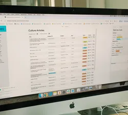 A desktop monitor displaying a list of articles in The Ubyssey's new content management system.