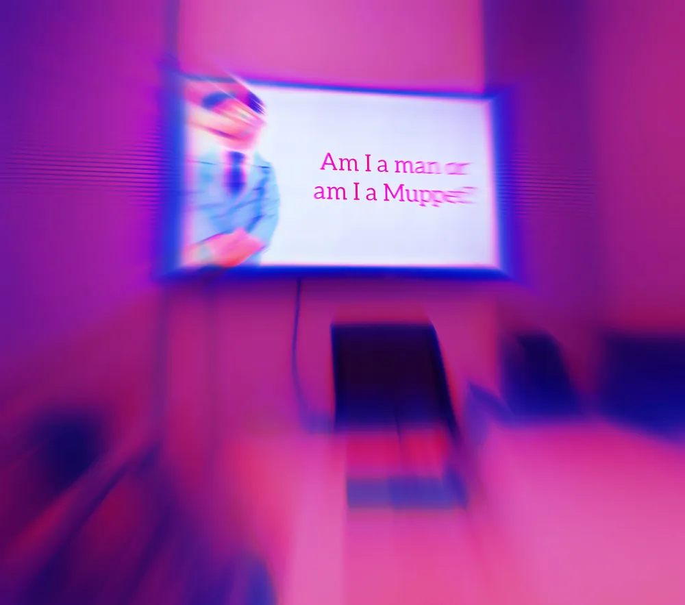 A photo of The Ubyssey's board room, edited to be hot pink and blurry.