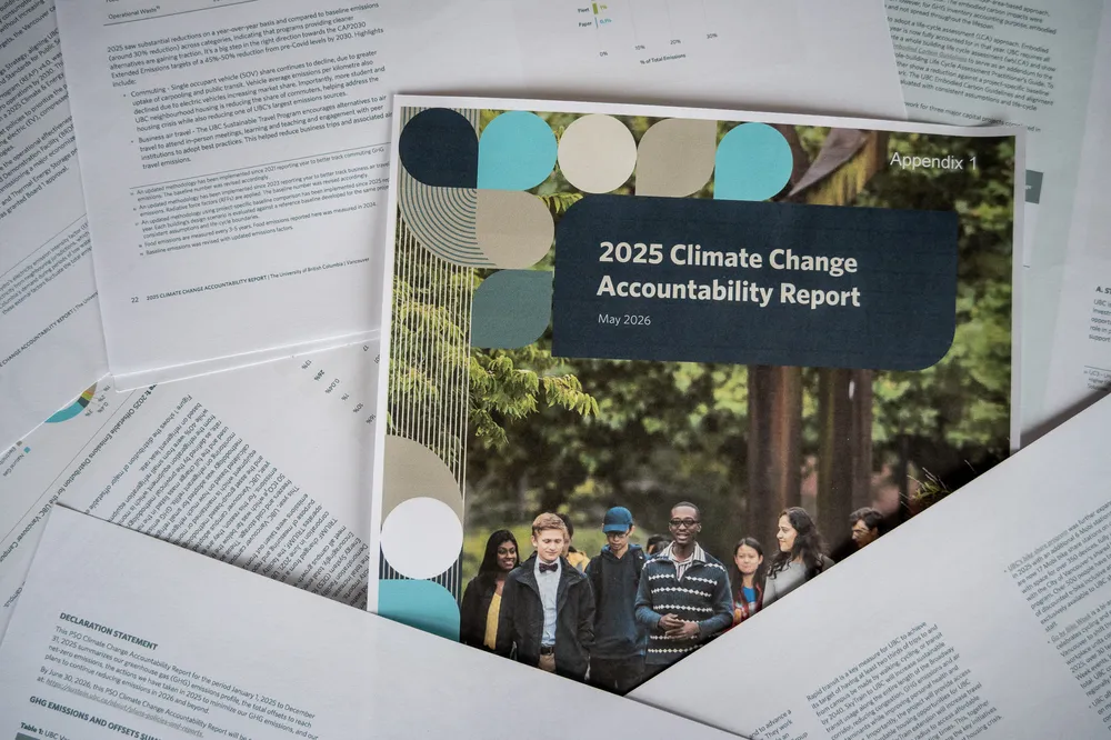 A photo of UBC's 2025 "Climate Change Accountability Report" pages scrambled across the frame.