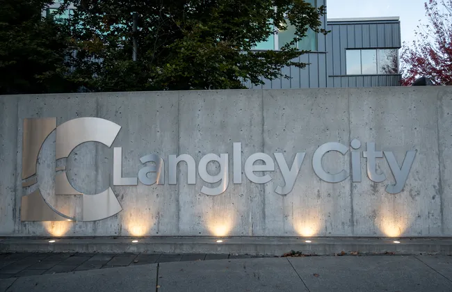 The sign outside Langley City Hall in the evening.