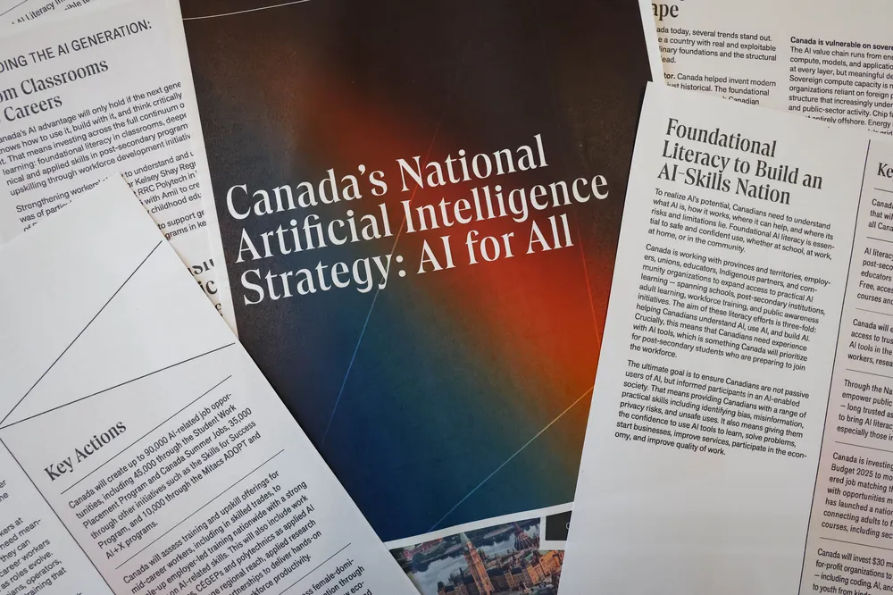 A photo of random pages from a document titled "Canada's National Artificial Intelligence Strategy: AI for All" spread out with the cover page in the middle.
