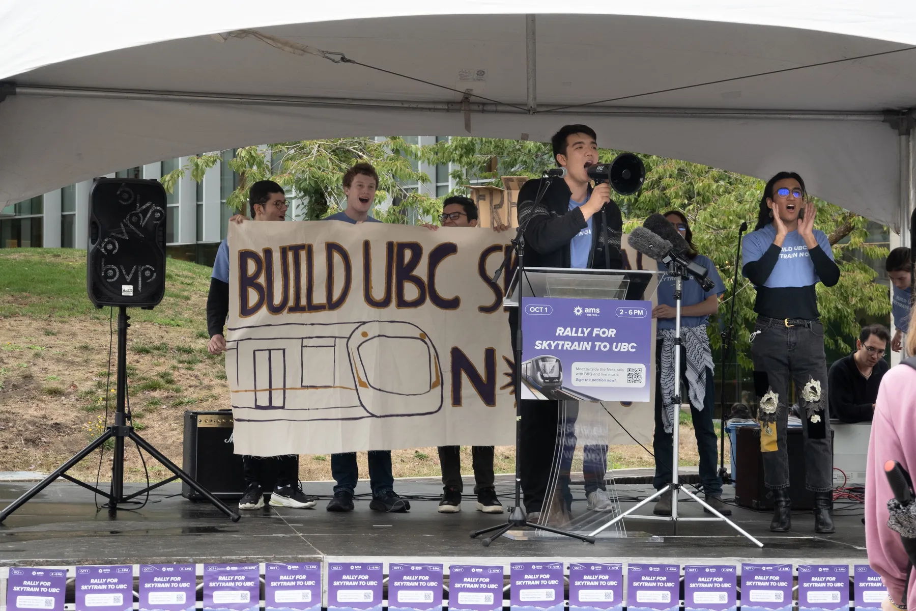 At the plaza outside the Nest, Yi-Kieran addresses the crowds.