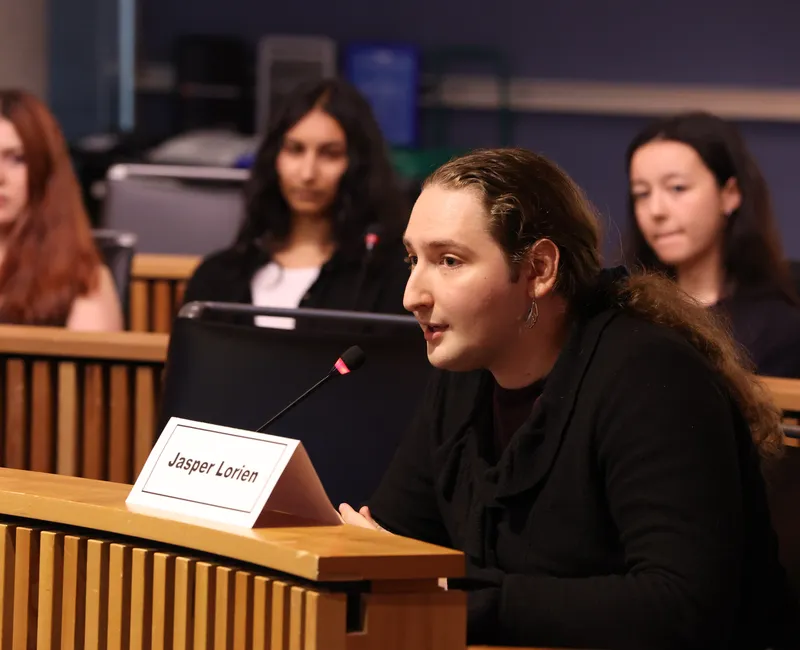 A person speaks into a microphone.