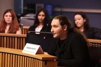 A person speaks into a microphone.
